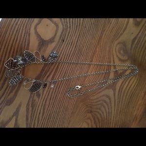 Long necklace with earthy tones .